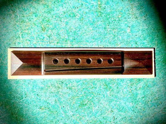 Braz Rosewood pyramid Bridge with modern saddle compensation and 2 5/16” hole spacing​